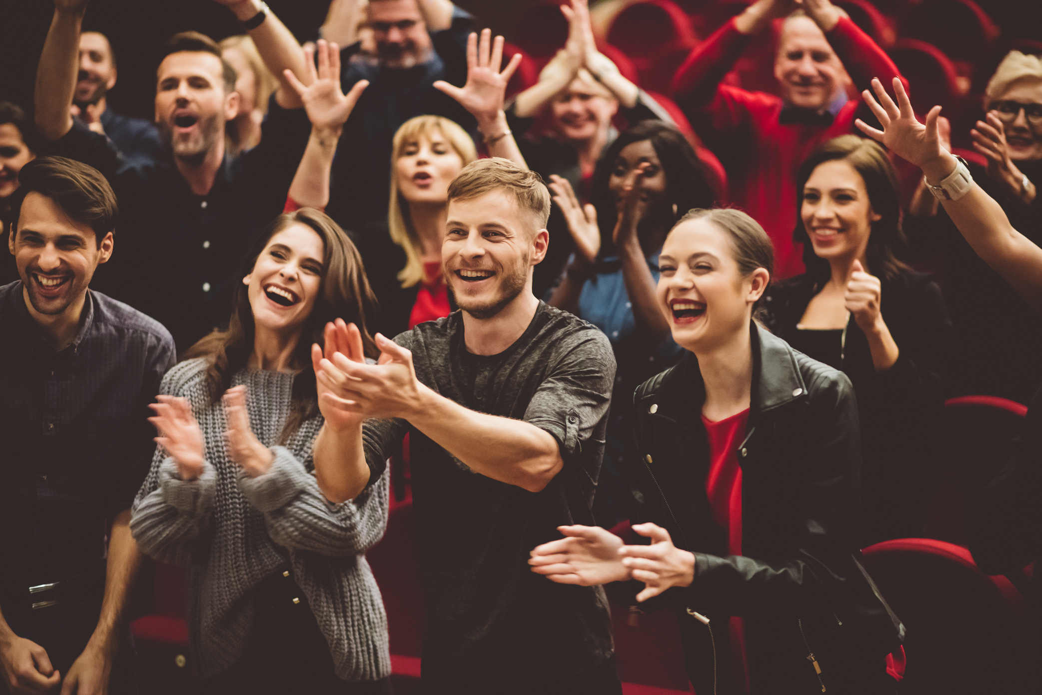 Happy audience applauding in the theater